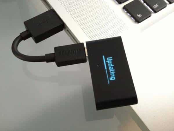 Compact black USB hub with multiple ports and LED indicator.