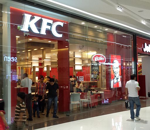KFC restaurant exterior in modern commercial building.