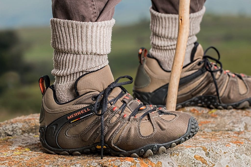 Well-equipped hikers sturdy boots on rugged outdoor terrain.