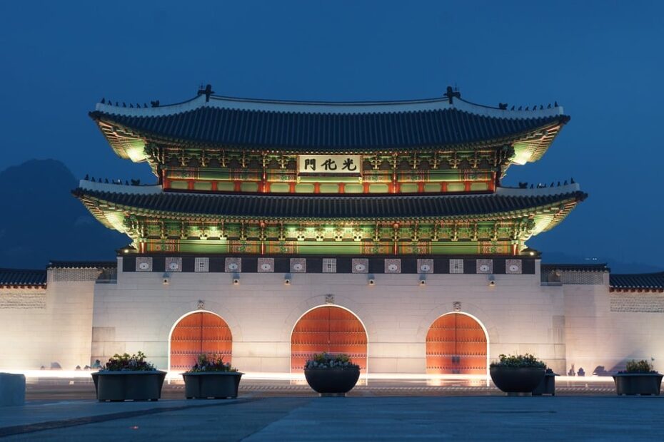 Majestic Asian palace shines in the night, a cultural masterpiece.