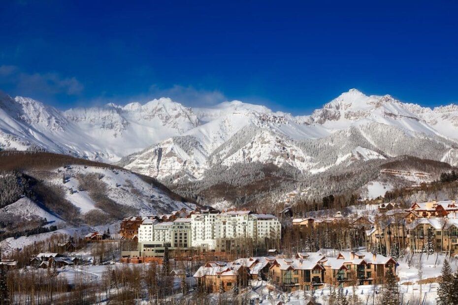 Enchanting winter town nestled in snowy mountain landscape.