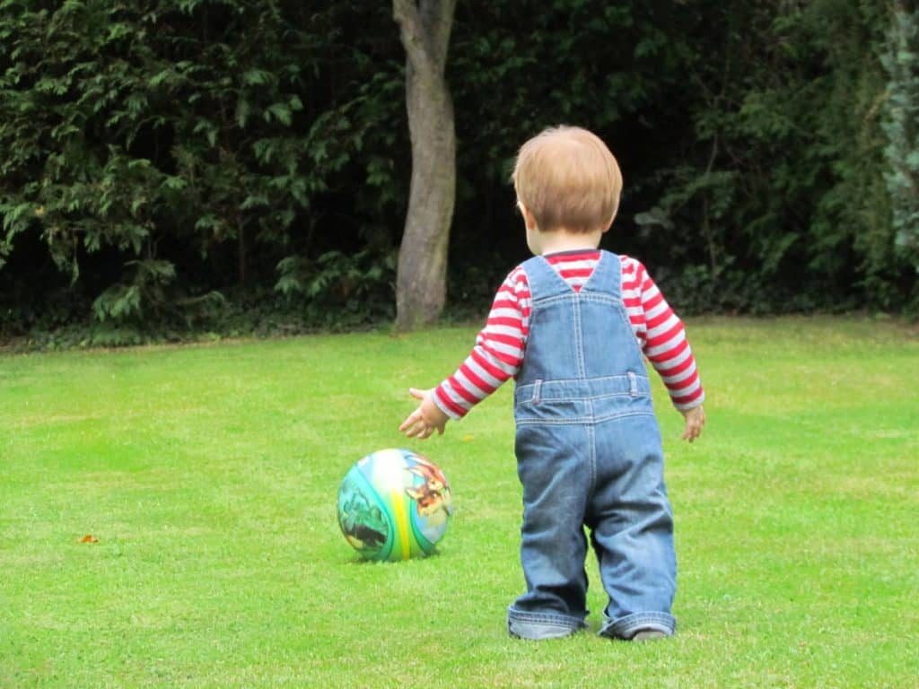 Toddler playing football